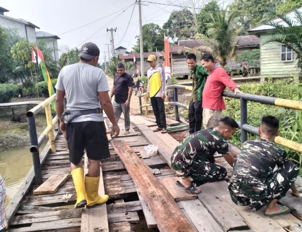 Perkuat Kemanunggalan TNI dan Rakyat, Satgas TMMD ke-129 Kodim 0313/KPR dan Warga Gotong Royong Perbaiki Jembatan jalan Desa